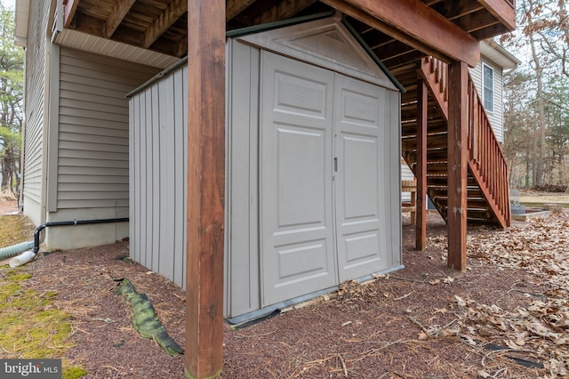 view of outbuilding with stairs and an outdoor structure