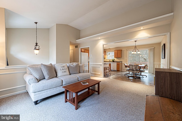 living area with light carpet and vaulted ceiling