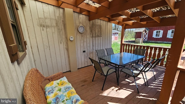 wooden terrace with outdoor dining area