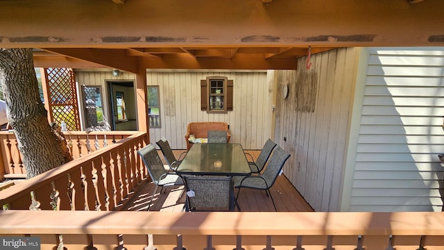 wooden deck featuring outdoor dining area