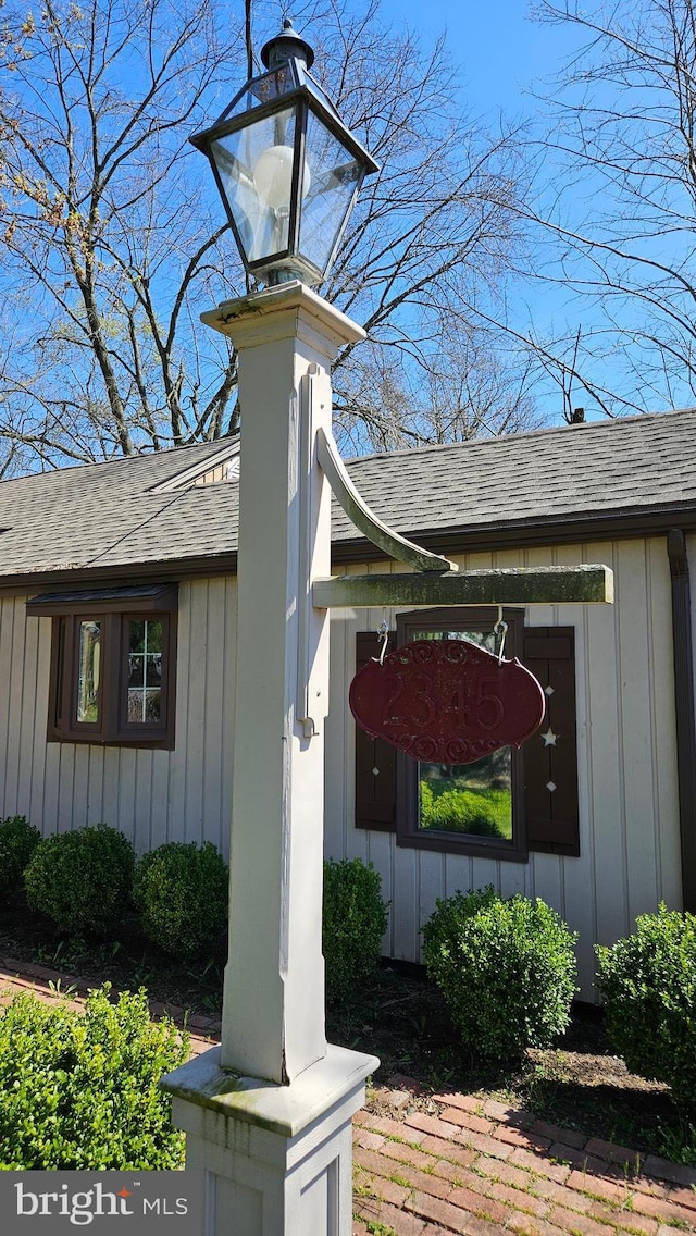 exterior space featuring a shingled roof, a chimney, and board and batten siding