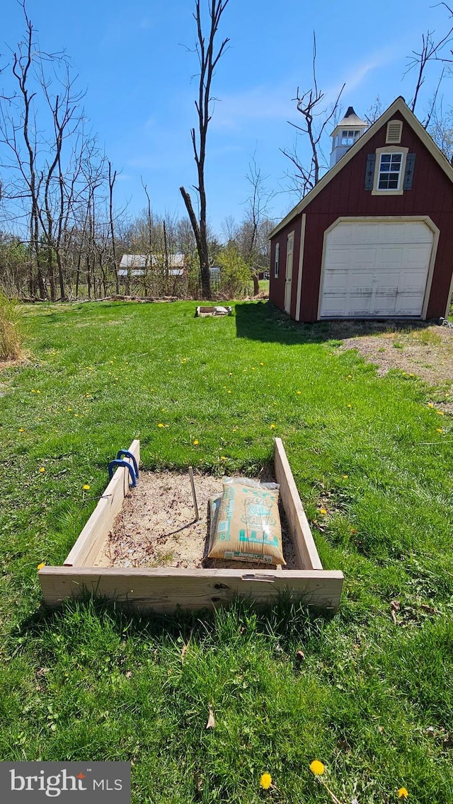 view of yard featuring an outbuilding, driveway, and a garage