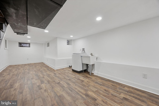 finished basement with recessed lighting, washer / clothes dryer, baseboards, and wood finished floors