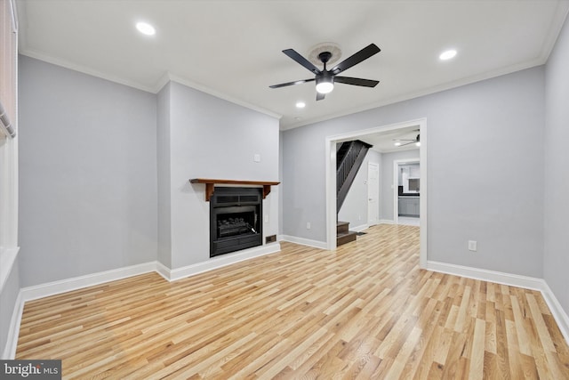 unfurnished living room with a ceiling fan, a fireplace, baseboards, and wood finished floors