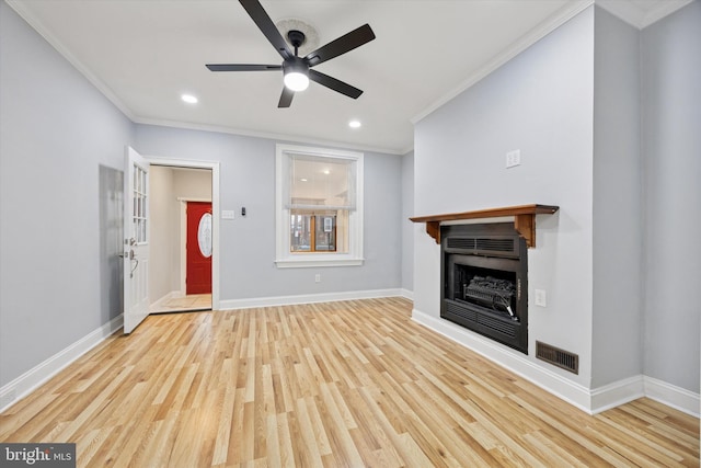 unfurnished living room with a fireplace, baseboards, wood finished floors, and ornamental molding