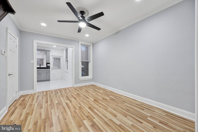 unfurnished living room with light wood finished floors, baseboards, ornamental molding, and recessed lighting