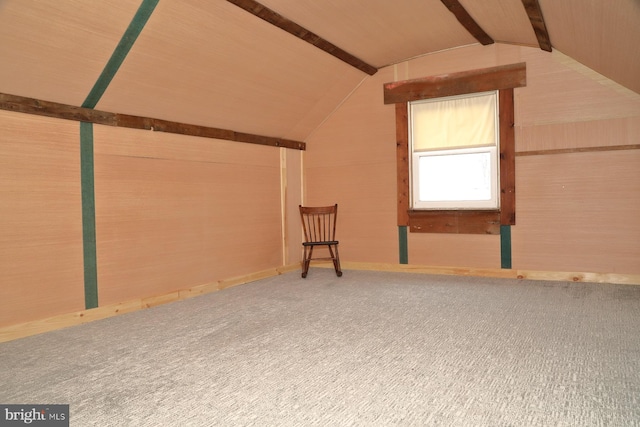 bonus room featuring lofted ceiling with beams and carpet floors