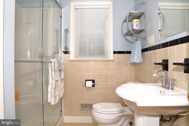 bathroom with toilet, a shower stall, and visible vents