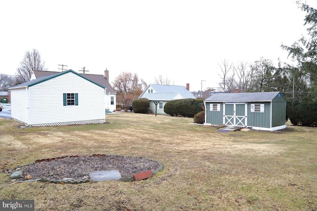 view of yard featuring a storage unit and an outbuilding