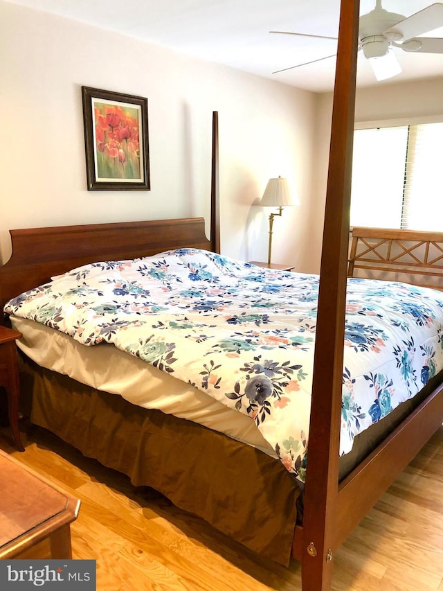 bedroom with a ceiling fan and wood finished floors