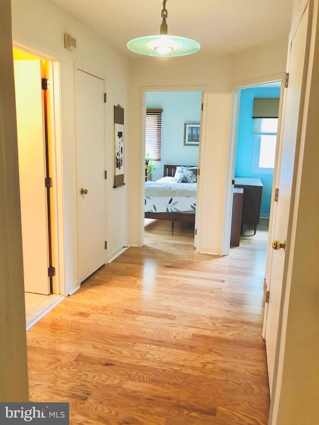 corridor with light wood-style floors