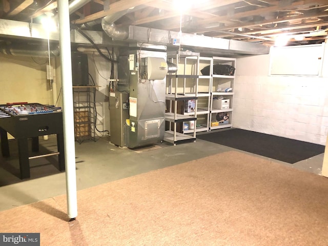 unfinished basement featuring heating unit