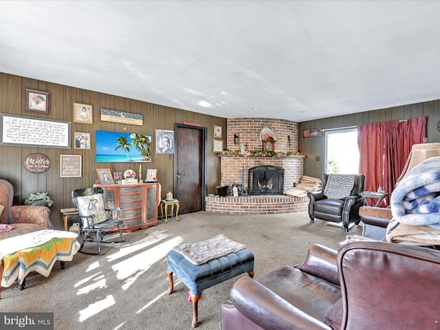 living room featuring wooden walls, a fireplace, and carpet flooring