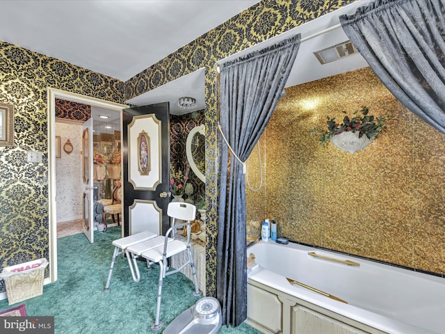 bathroom featuring visible vents, a bath, and wallpapered walls