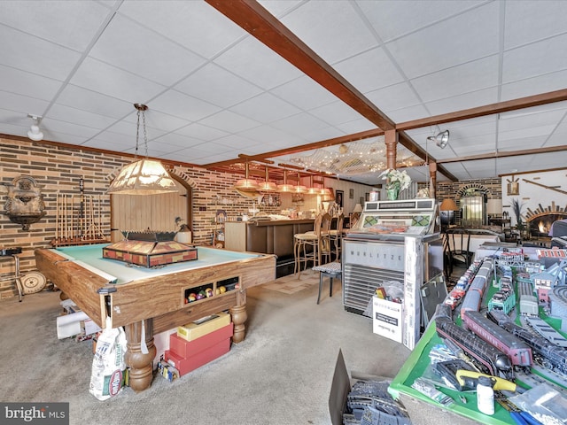 recreation room featuring a paneled ceiling, carpet, pool table, and brick wall