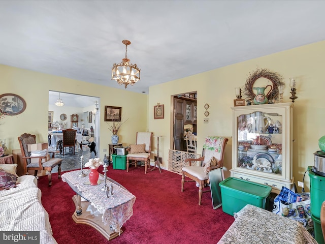 carpeted living room with a notable chandelier