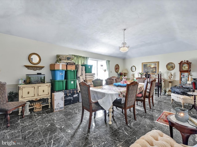 dining space featuring marble finish floor