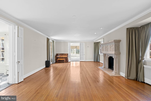 unfurnished living room with a fireplace with raised hearth and crown molding