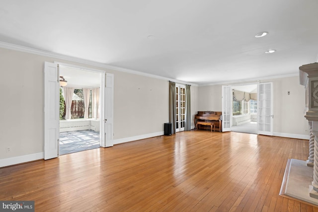 unfurnished living room with a wealth of natural light and crown molding