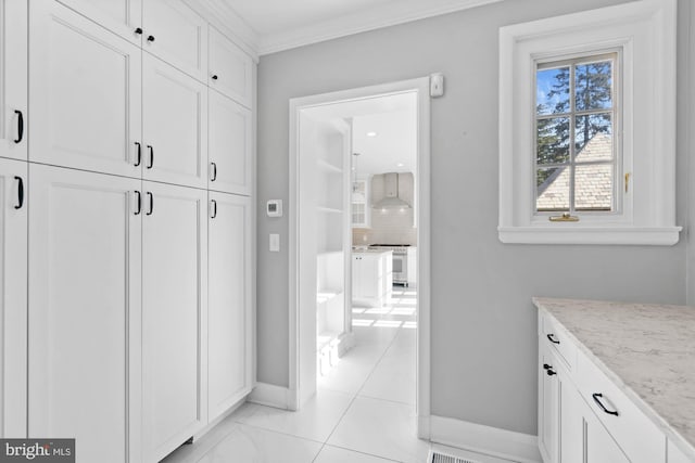 interior space featuring baseboards and crown molding