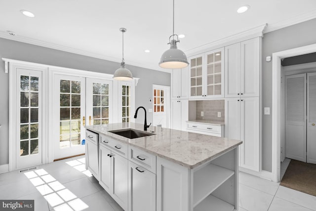 kitchen featuring white cabinets, ornamental molding, open shelves, and a sink