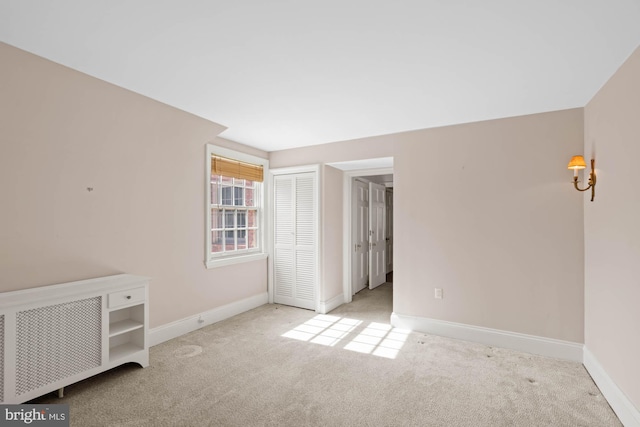 empty room with carpet floors and baseboards