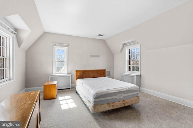 carpeted bedroom with radiator, visible vents, vaulted ceiling, and baseboards