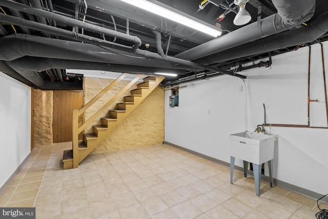 unfinished below grade area featuring stairs and tile patterned floors