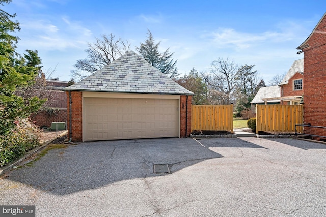 detached garage featuring fence