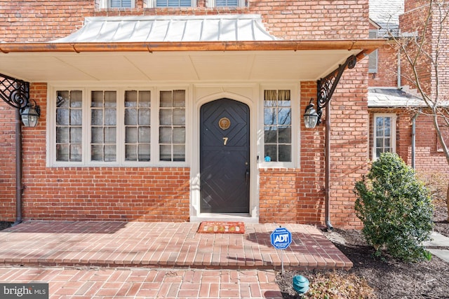 entrance to property featuring metal roof and a standing seam roof