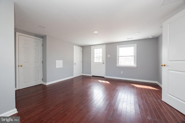 interior space featuring visible vents, baseboards, and wood finished floors