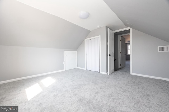 bonus room featuring lofted ceiling, baseboards, visible vents, and carpet flooring