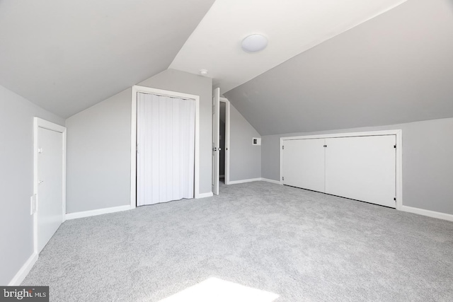 bonus room with lofted ceiling, baseboards, and carpet floors