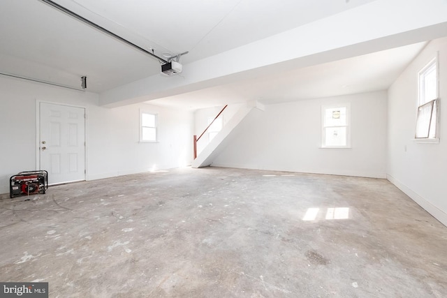 garage with baseboards and a garage door opener