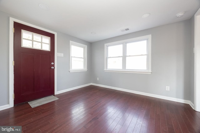 entrance foyer featuring dark wood-style flooring, visible vents, and baseboards