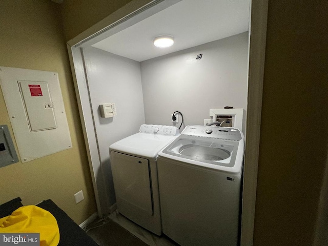 washroom featuring laundry area, electric panel, and separate washer and dryer