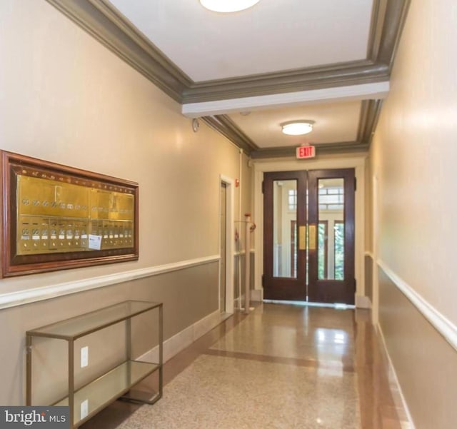 interior space with crown molding, baseboards, and speckled floor