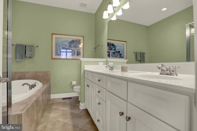 bathroom featuring tile patterned floors, toilet, double vanity, a bath, and a sink