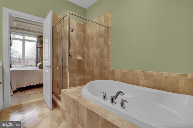 ensuite bathroom featuring tile patterned flooring, a shower stall, a bath, and ensuite bathroom