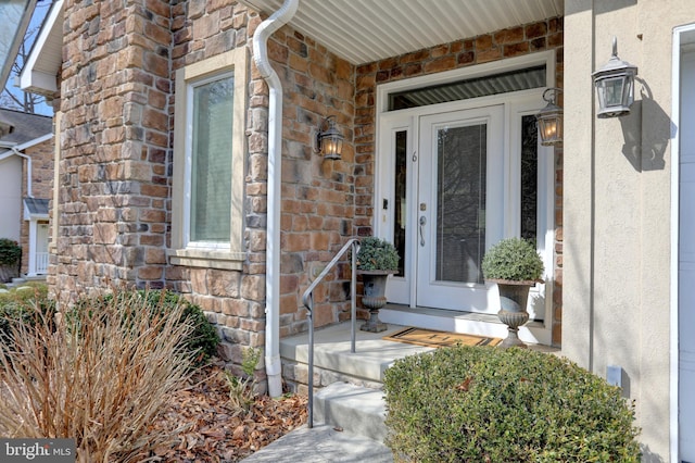 property entrance with stone siding