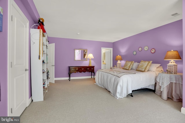 carpeted bedroom with baseboards and visible vents