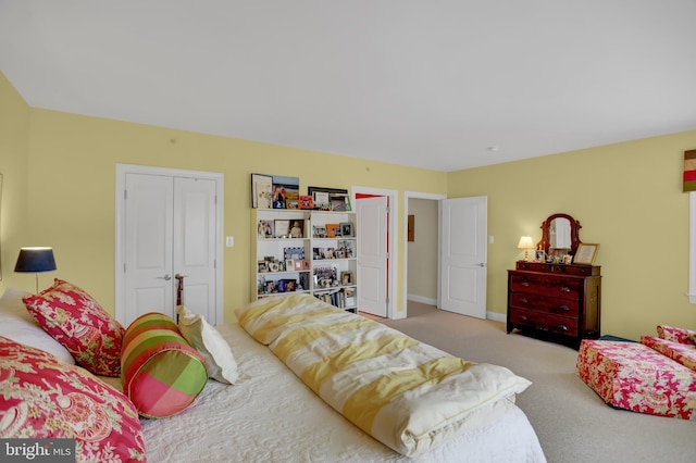 bedroom featuring carpet and baseboards