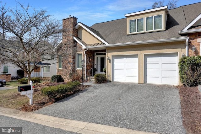 view of front of property featuring a shingled roof, stucco siding, a chimney, stone siding, and driveway