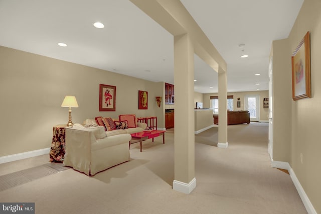 living area with recessed lighting, baseboards, and light carpet