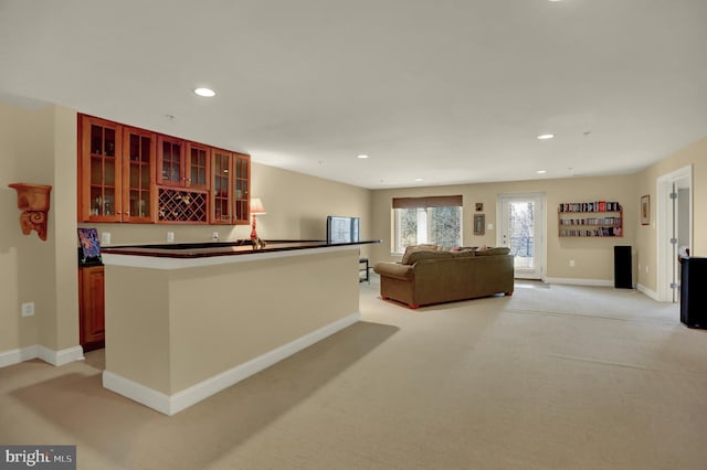 interior space with recessed lighting, indoor wet bar, baseboards, and light carpet