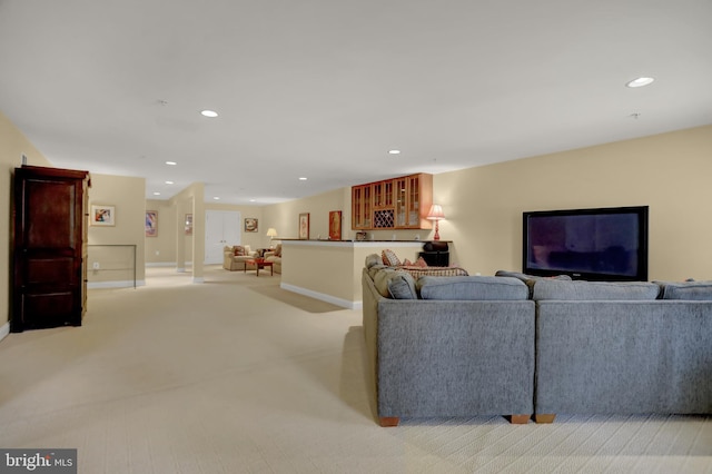 living room featuring light carpet, recessed lighting, and baseboards