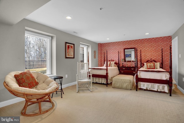 bedroom featuring recessed lighting, an accent wall, and baseboards