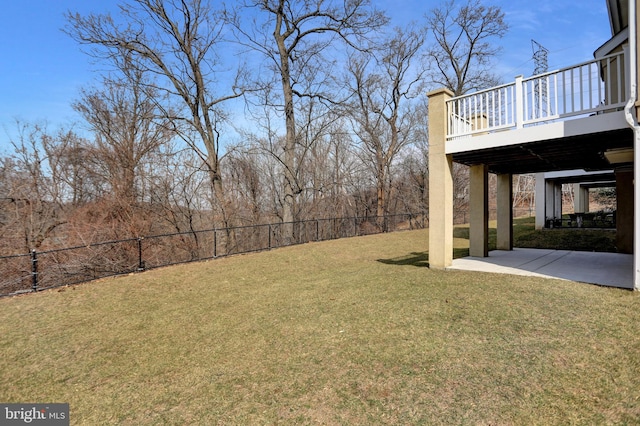 view of yard with a patio, fence, and a wooden deck