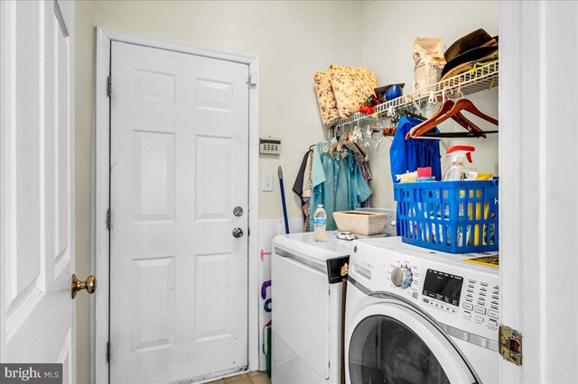 laundry room featuring separate washer and dryer and laundry area