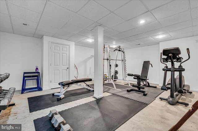 workout area with baseboards and a drop ceiling